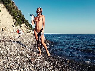Travel slut teases a videographer and fucks him on the beach